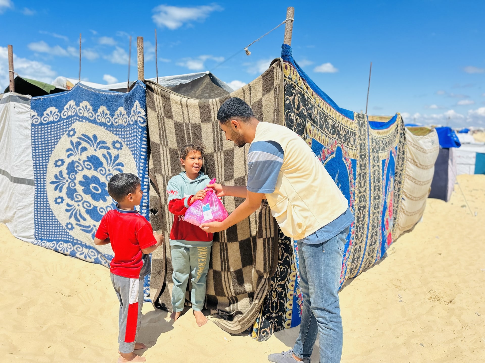 Displaced families in Gaza receive food packages from our field team.