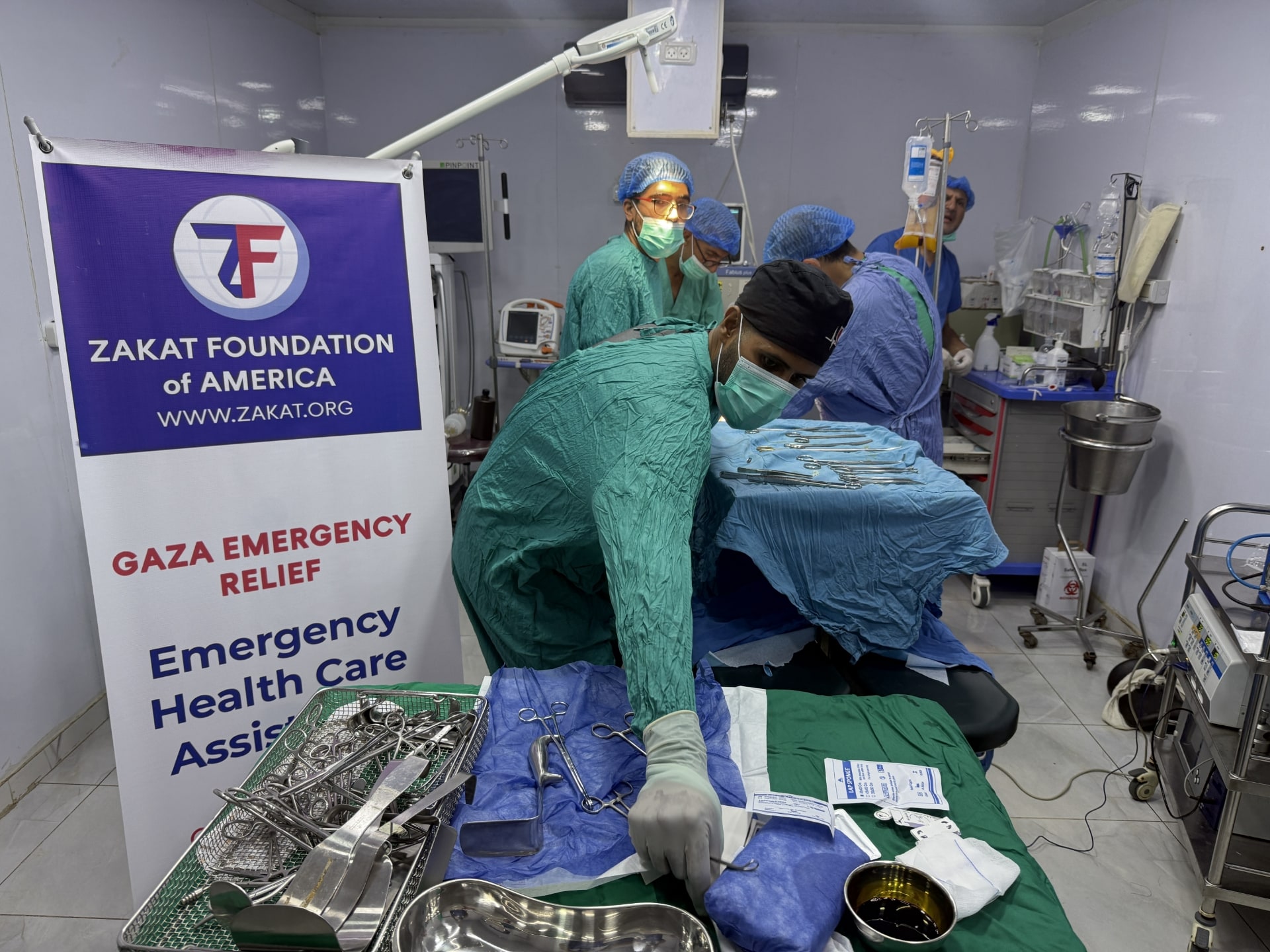 Doctors at Kuwait Specialty Field Hospital in Gaza treat a patient.