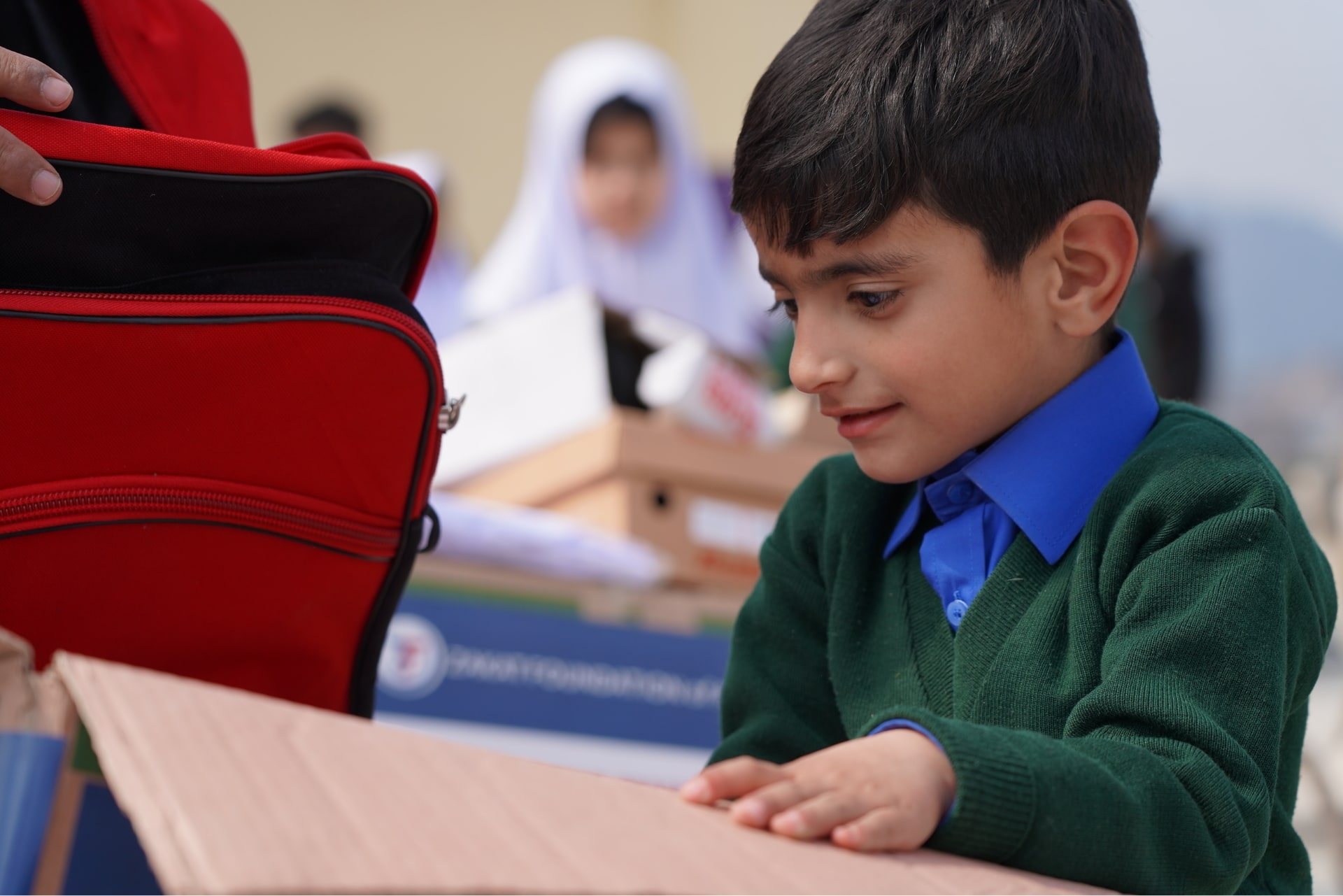 A young sponsored orphan from Pakistan receives essentials for school.