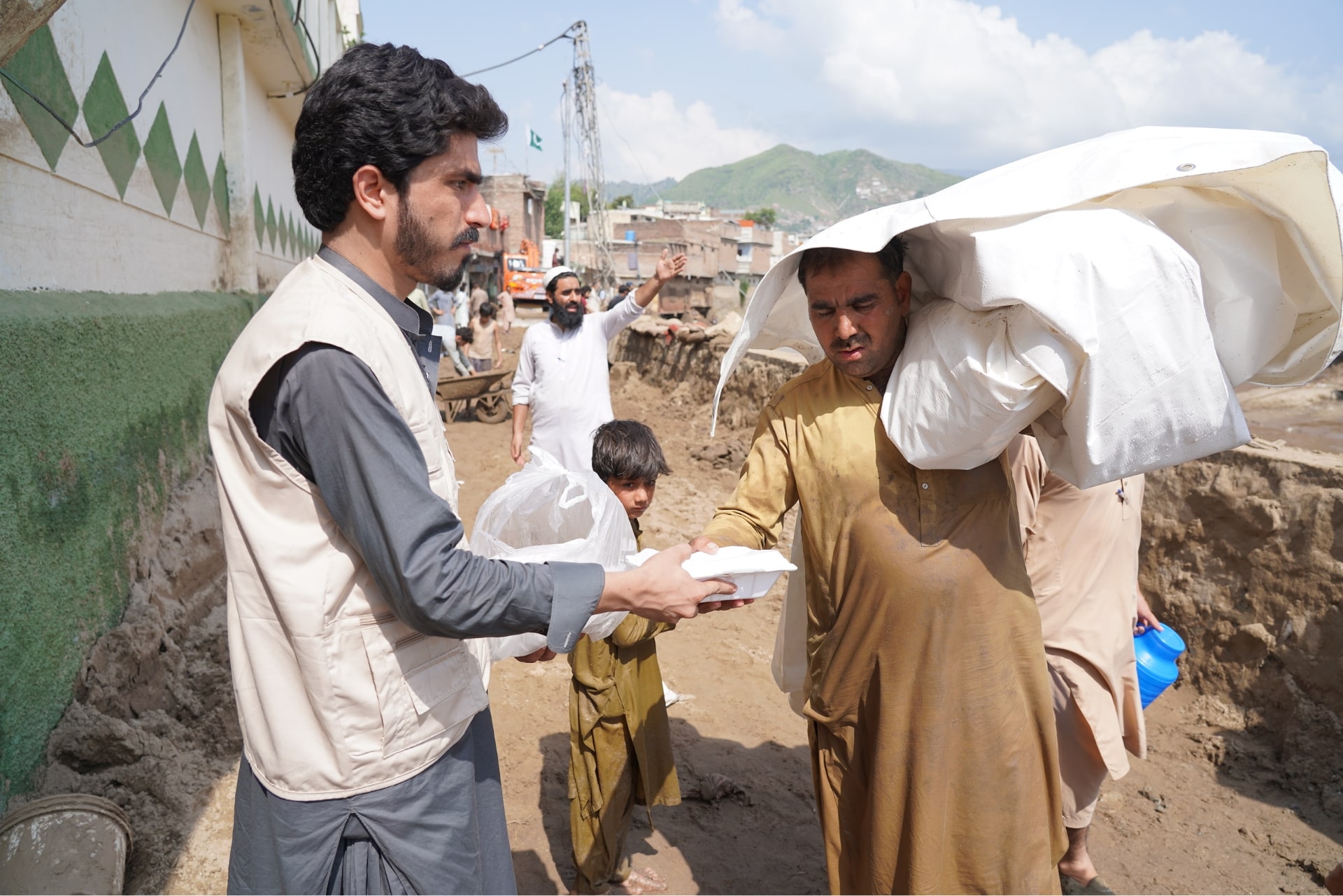 Hot meals are a welcomed relief as Pakistan flood survivors seek safety.
