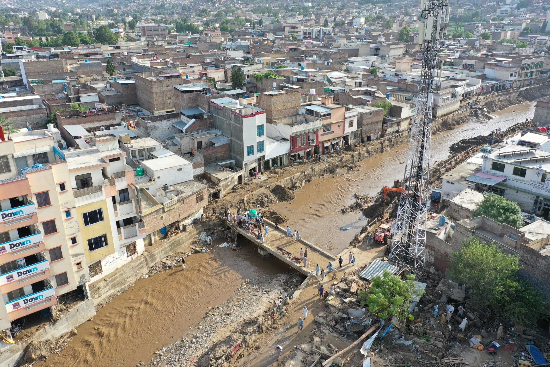 Our team crosses over flood waters with essentials for Pakistan flood affected families.