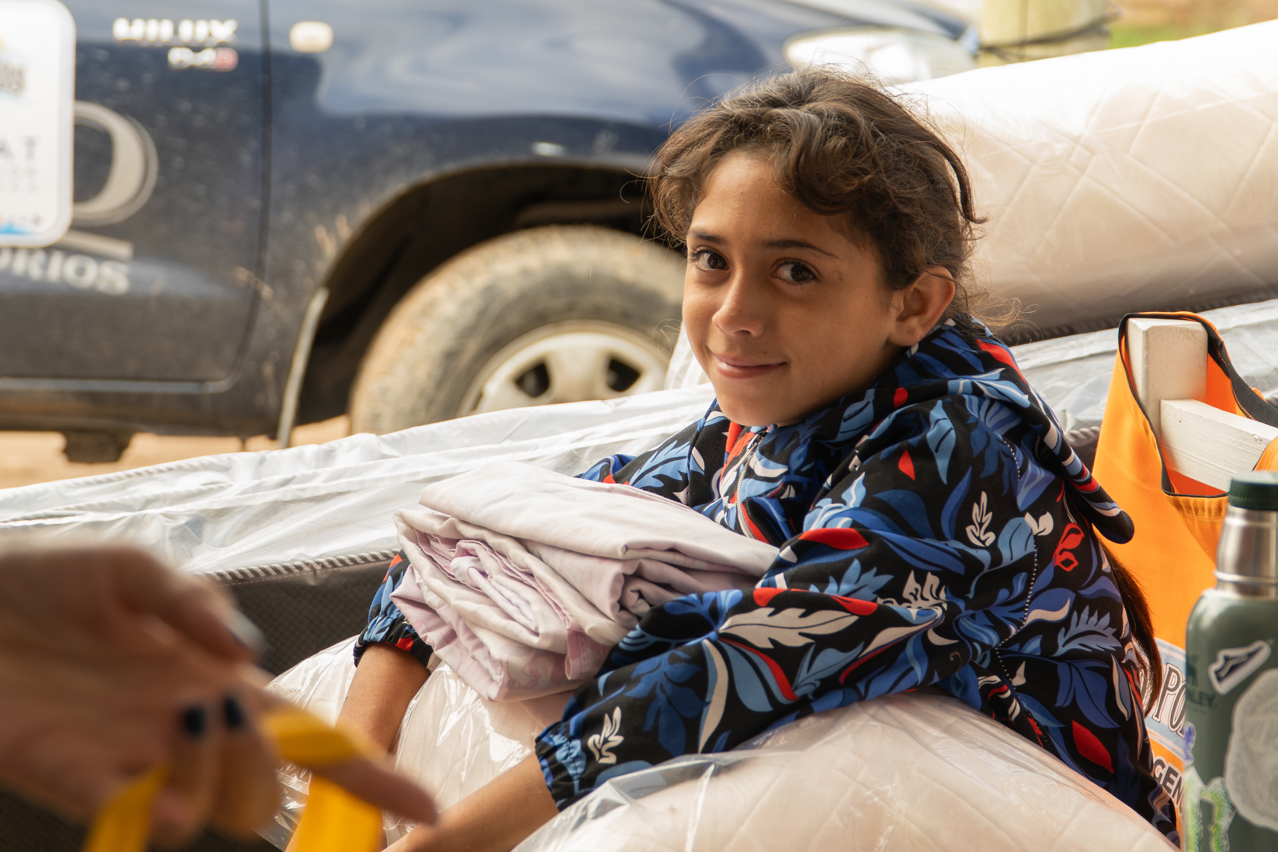 A child in Argentina is happy tor receive emergency support following the floods