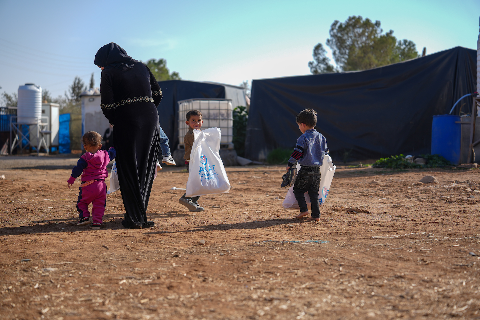 A mother collects winter items from our team for herself and her children