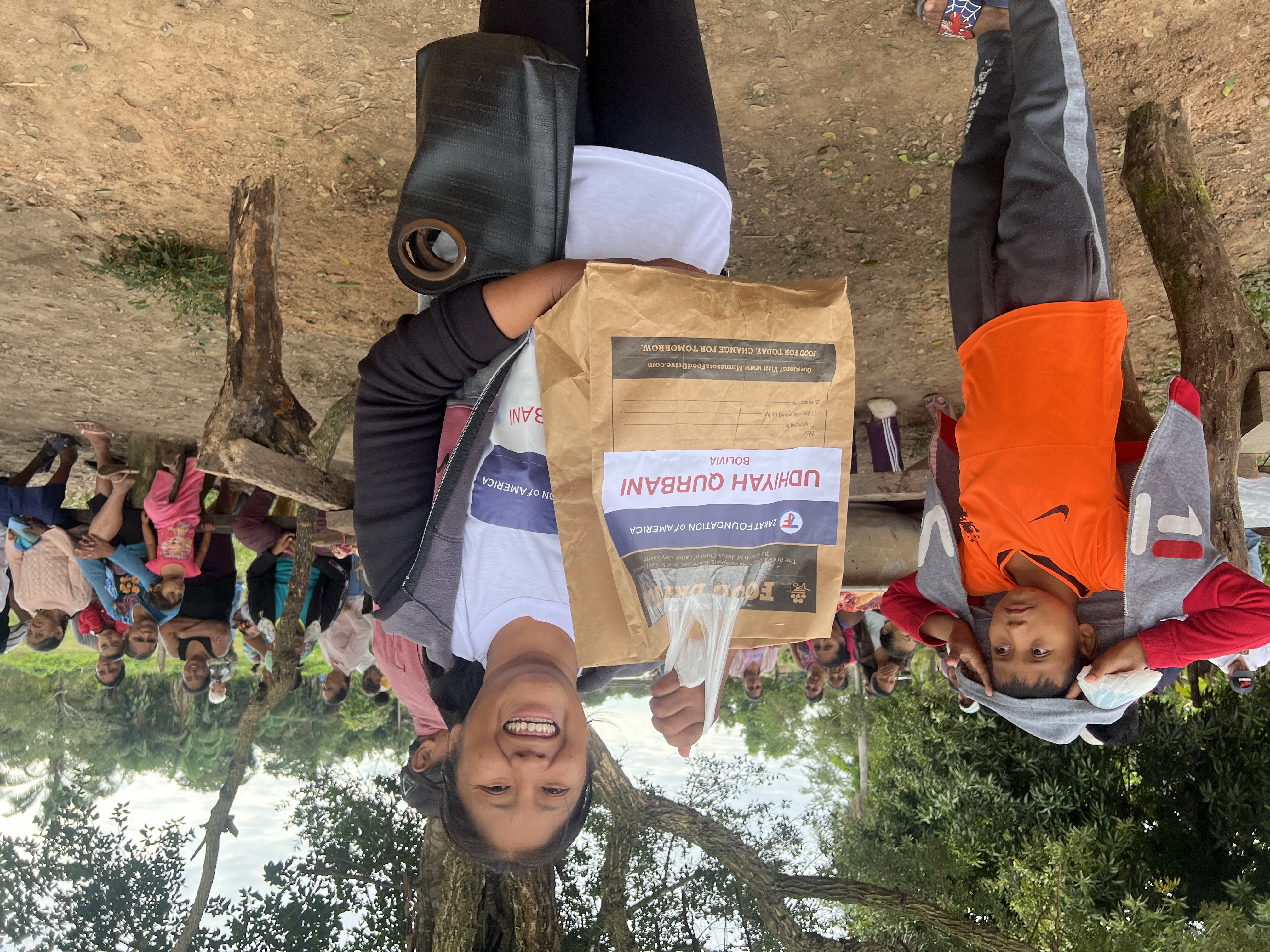 A mother in Bolivia is all smiles as she receives nourishing Qurbani meat