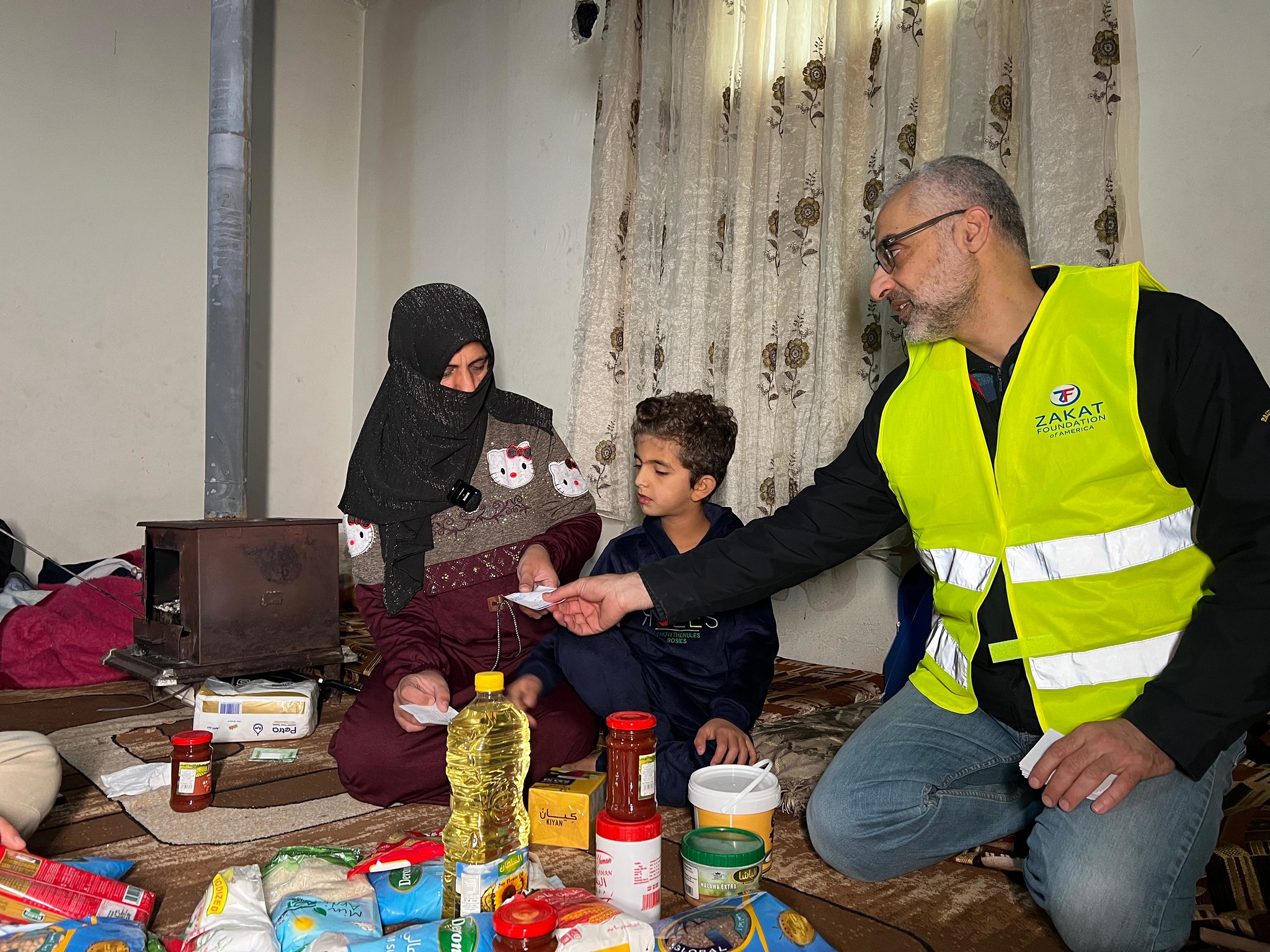 A mother in Lebanon receive winter food staples for her family