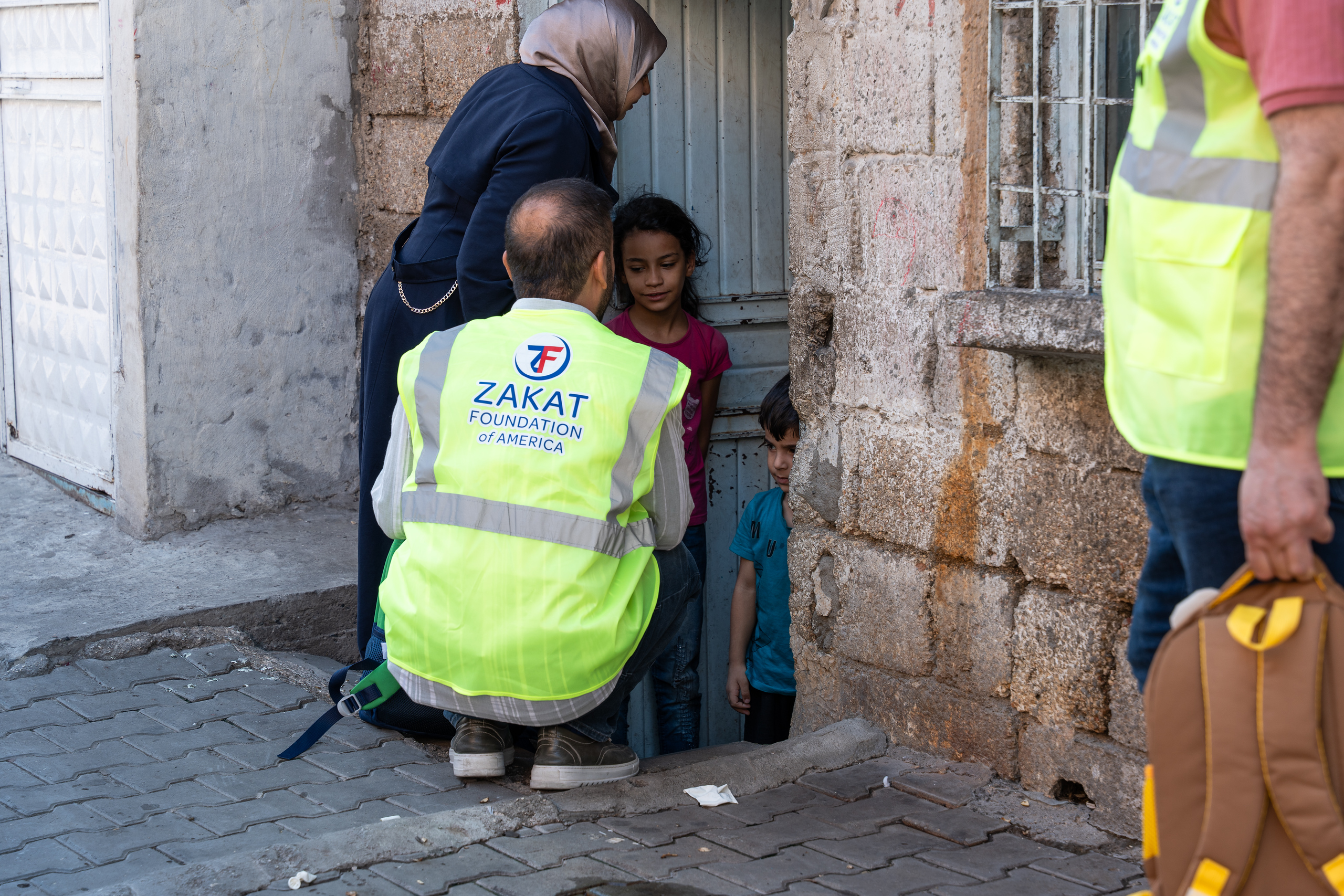 A tender moment between our team as they deliver school bags to children in Türkiye