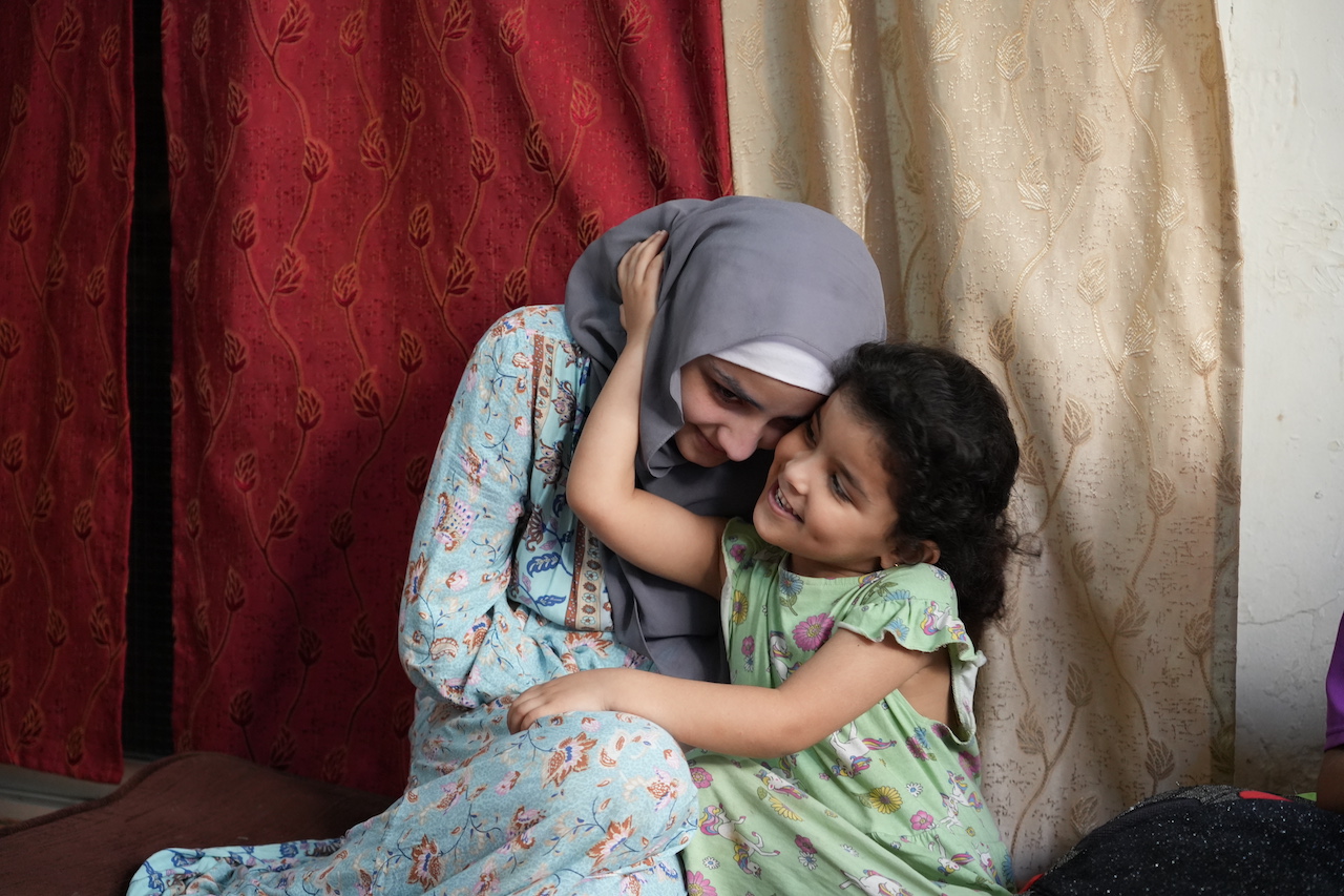 A tender moment between two sponsored orphaned children