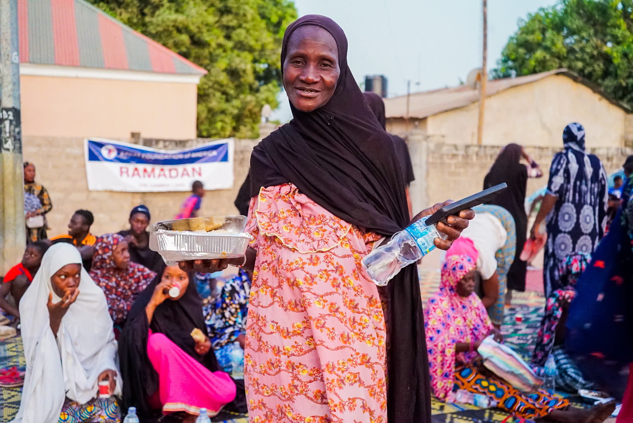 A women in Gambia is excited to break her fast on the gifted iftar meal