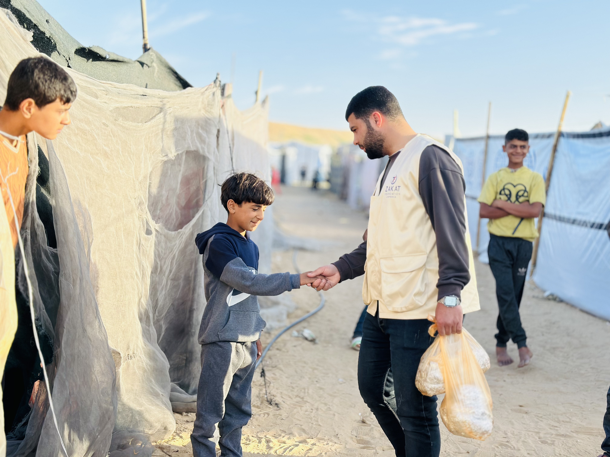 A young boy in Gaza greets our teams during their iftar meal distribution