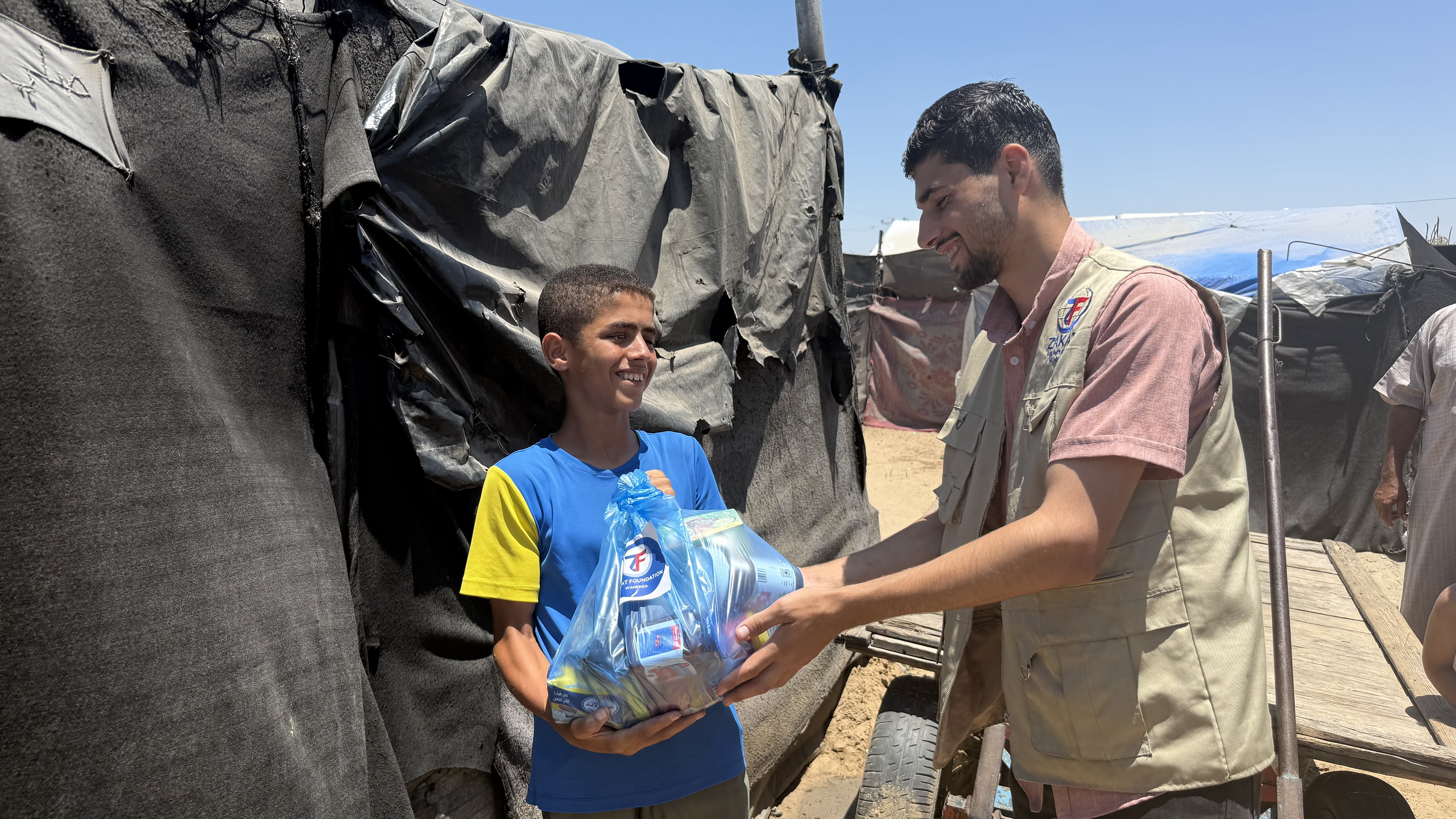 A young child in Gaza shares his joy in receiving a food package