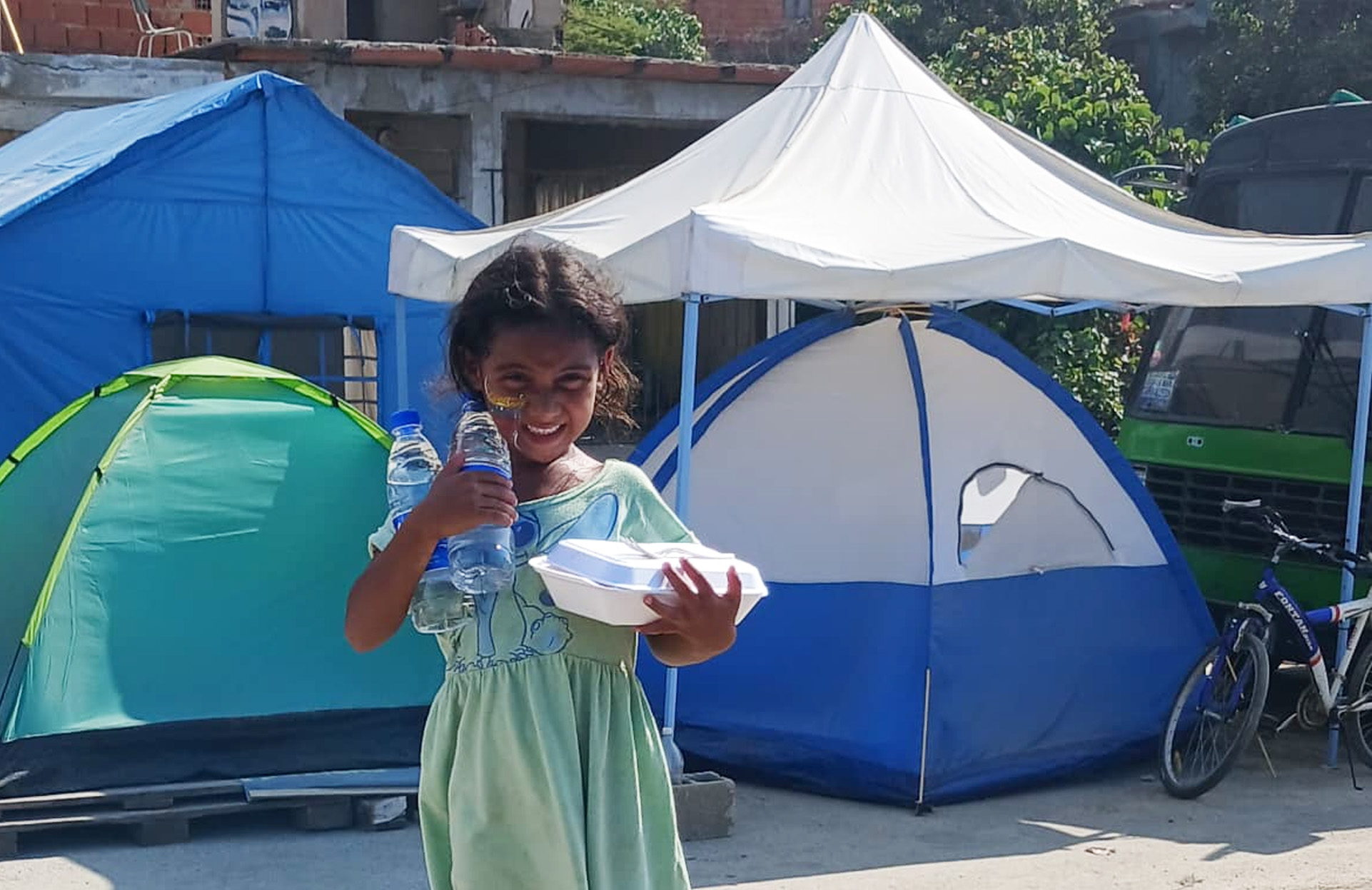 A young child show her excitement at receiving a warm meal
