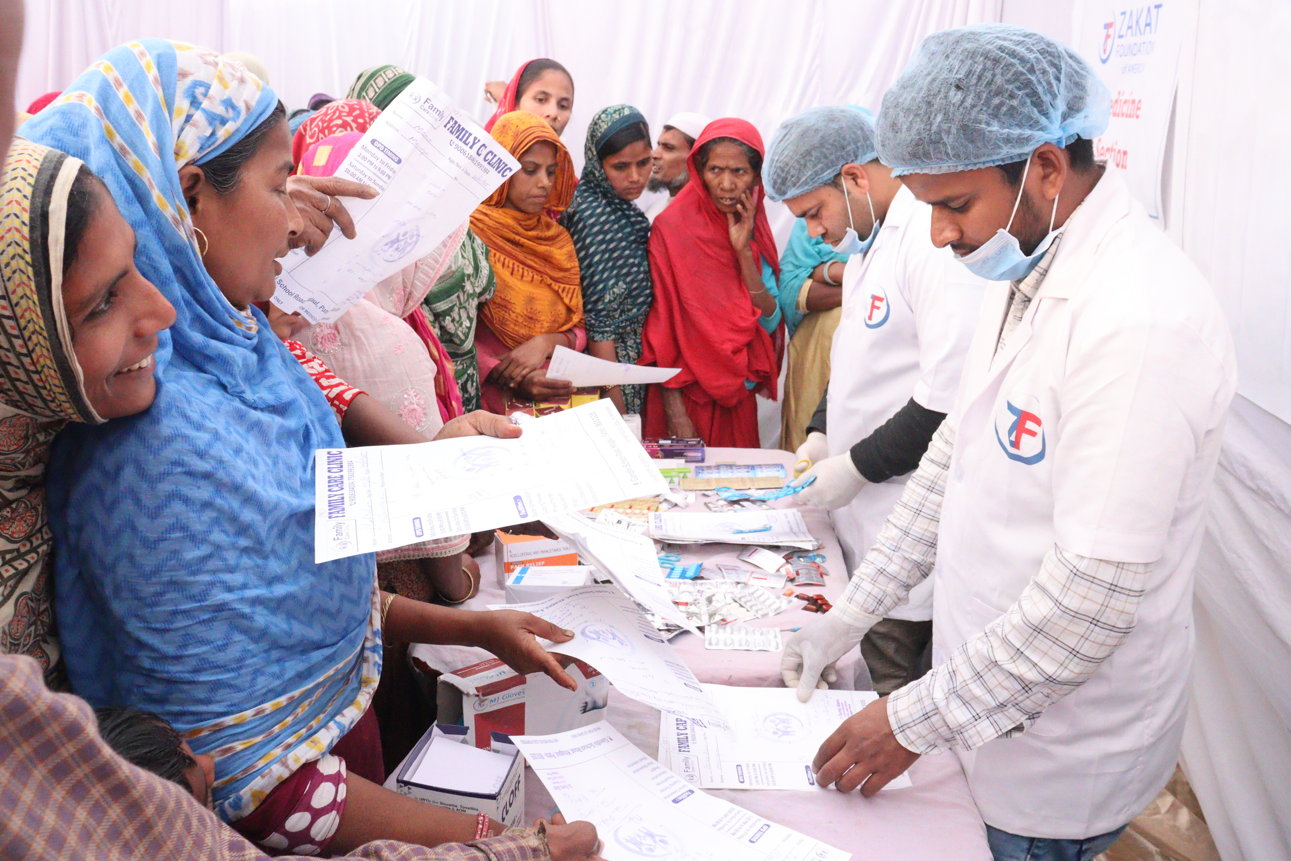 After receiving treatment, patients at our medical camp in India collect their medication