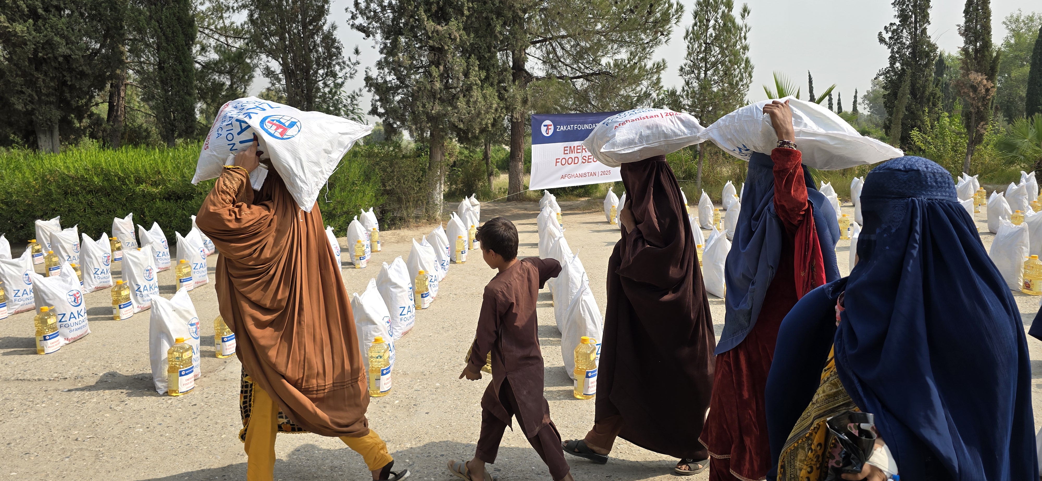 An Afghan refugee family returning to Nangarhar receives food essentials