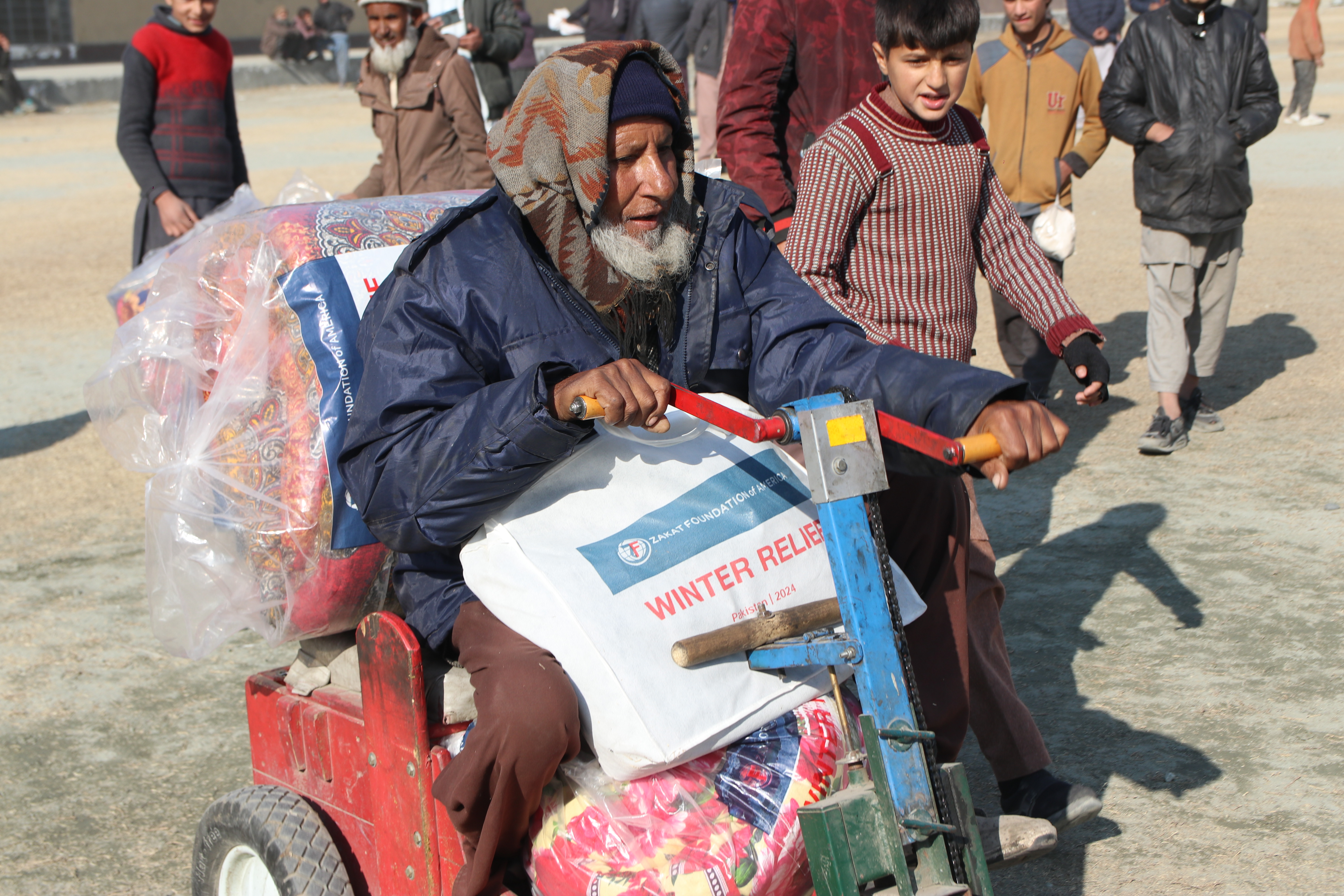An elderly man from Pakistan receives winter essentials for his family
