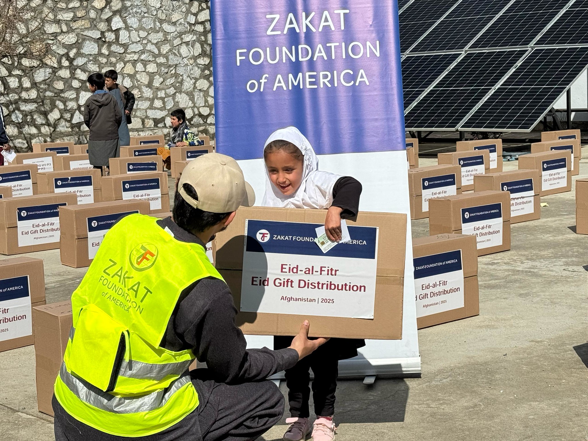 An orphan girl in Afghanistan is excited to receive her Eid gift thanks to you