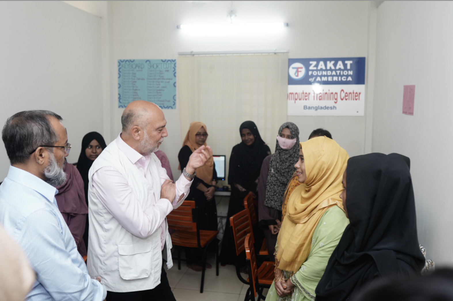 At our computer training center, students meet with Mr. Demir to share their experiences
