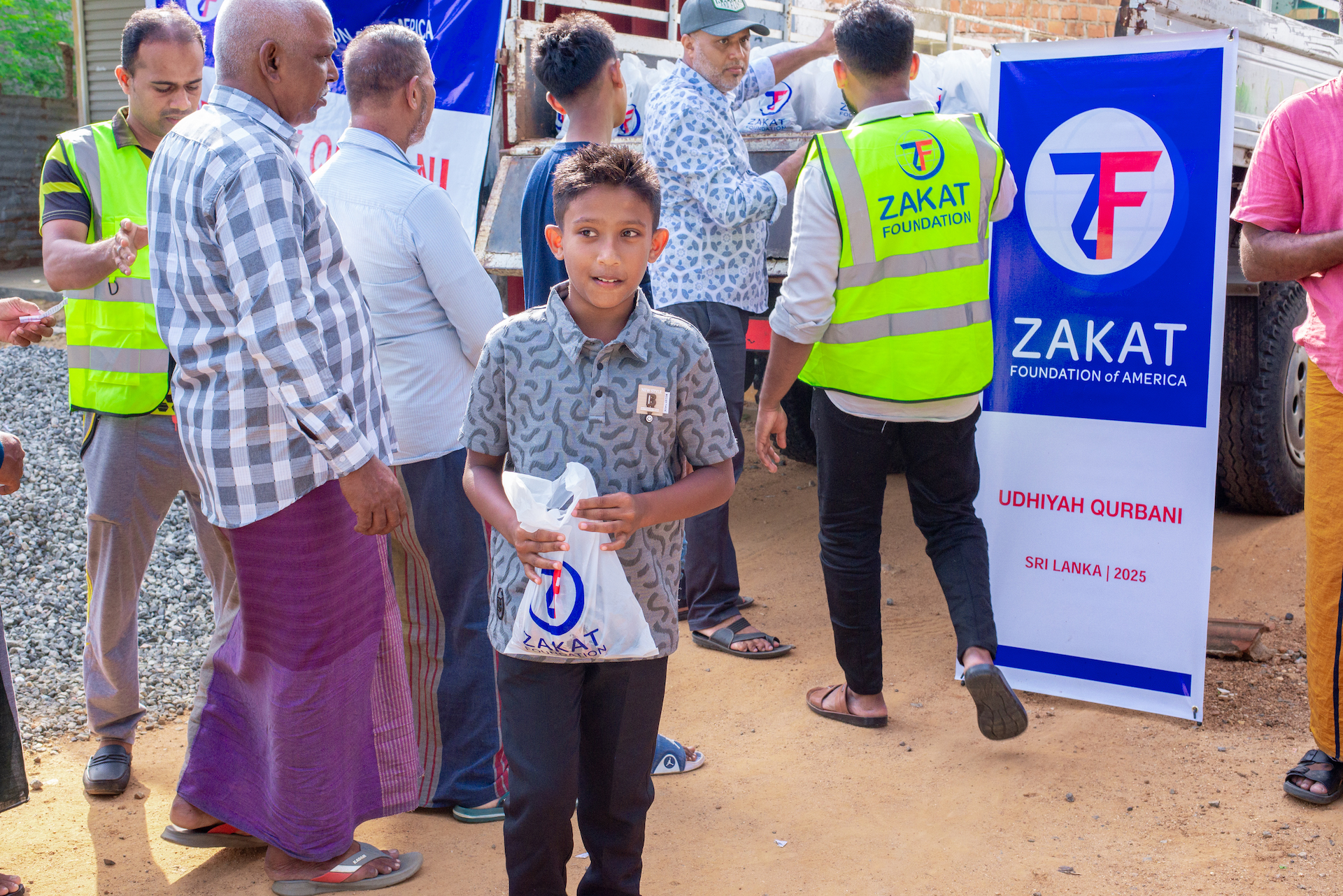 Children collect nourishing meat at our distribution for their mothers