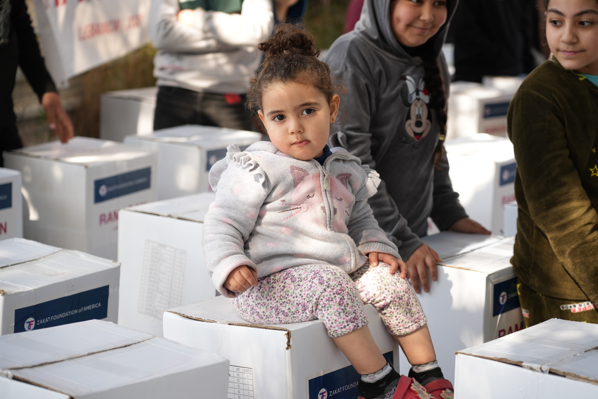 Children excitedly receive their Ramadan food package for nourishing meals