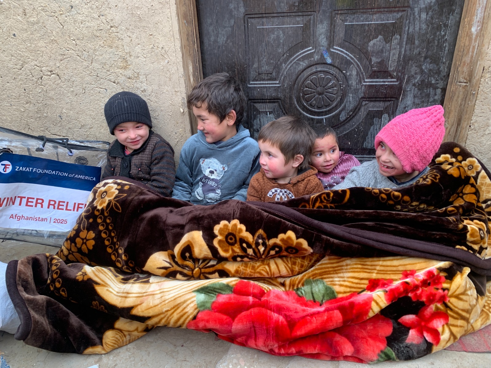 Children in Afghanistan enjoy the warmth and comfort of your support