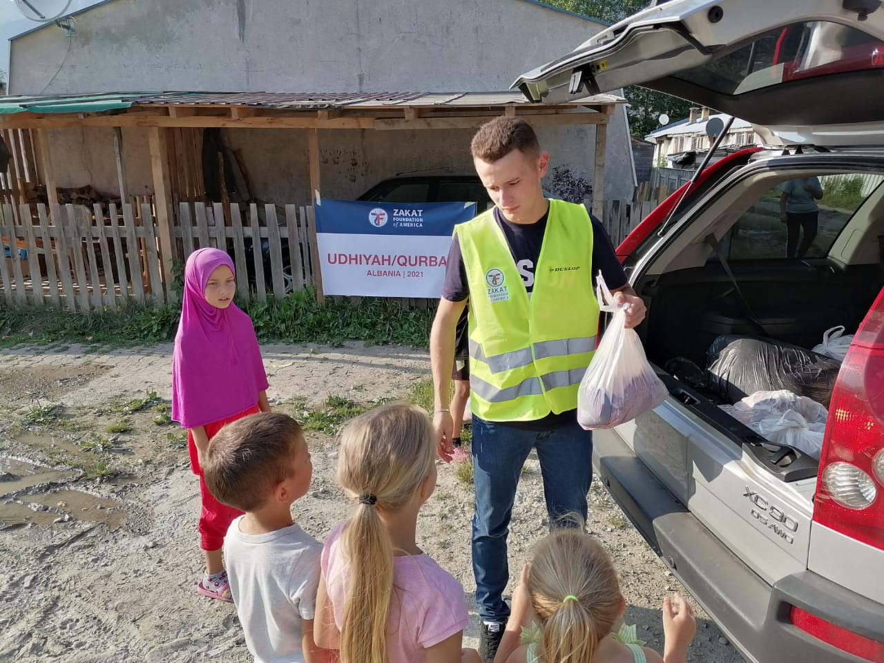 Children in Albania line up to collect Udhiyah-Qurbani meat packages for their families