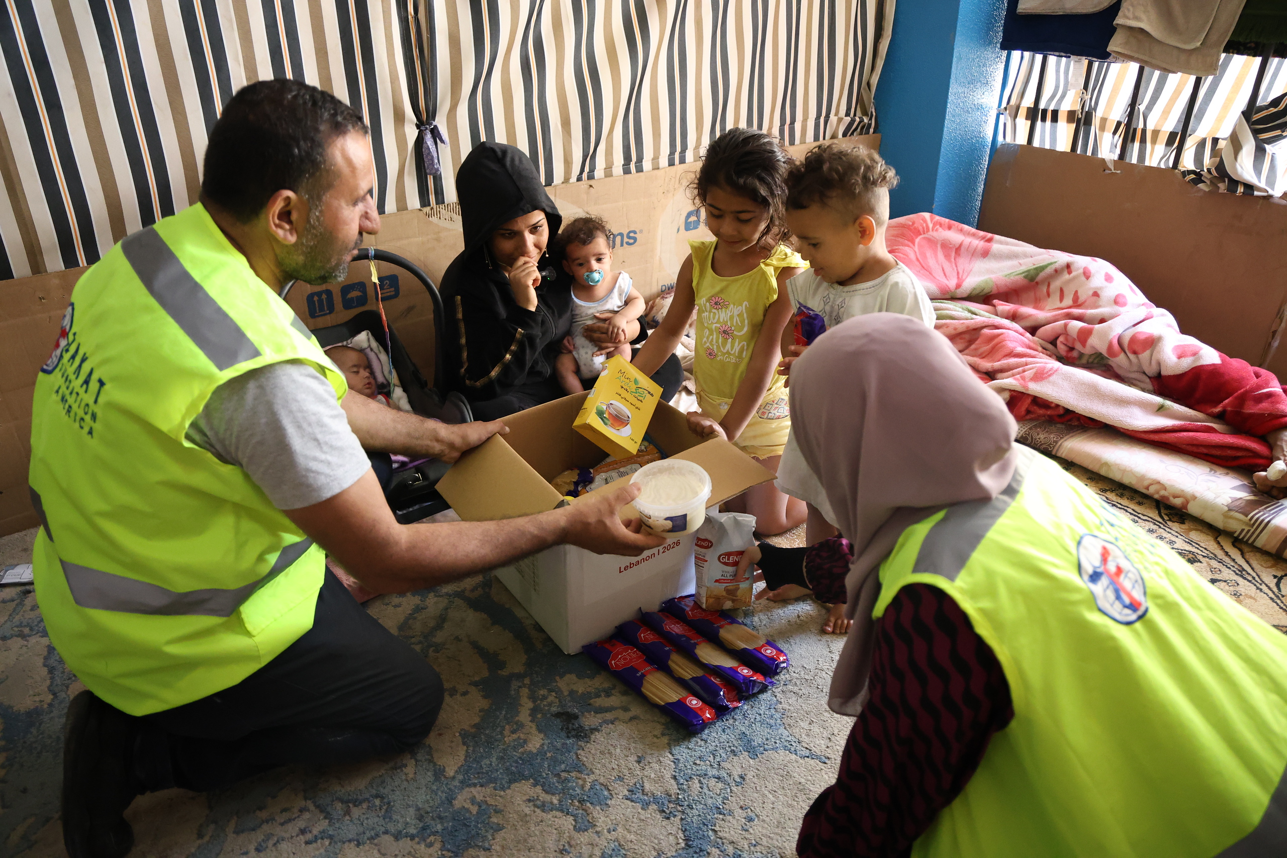 Children in Lebanon gather around our food package to enjoy the items inside