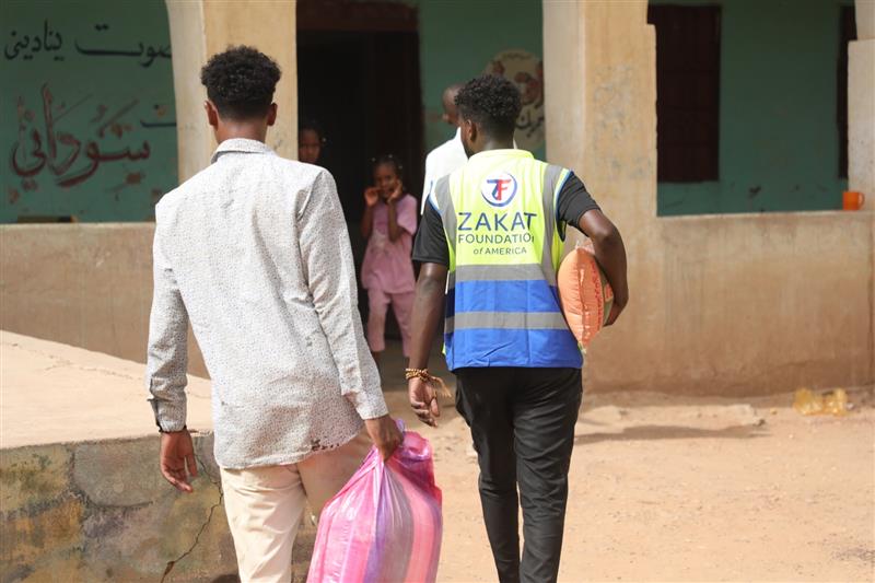 Children in Sudan wait eagerly for their food package as hunger grows