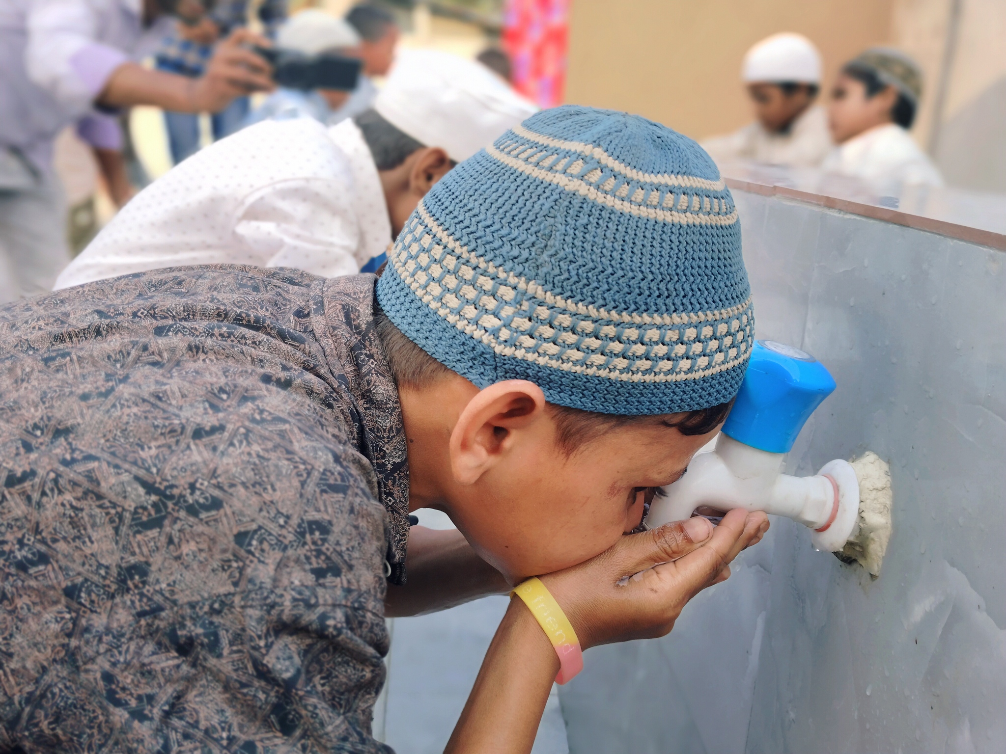 Children perform ablution at our stations ahead of prayer time in India