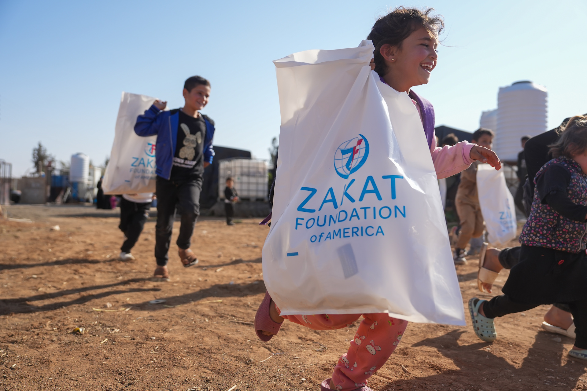 Children run home with their winter relief items