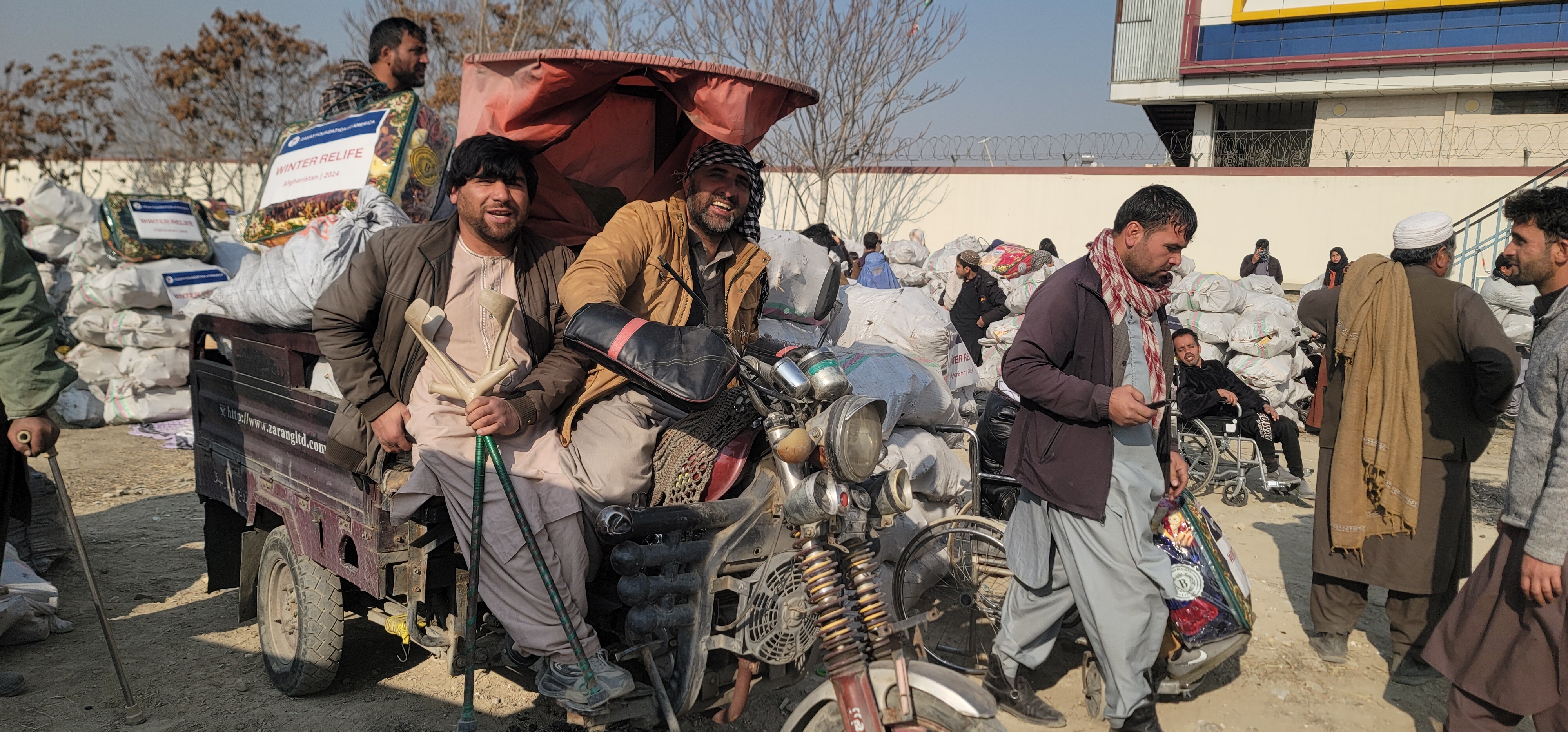 Families in Afghanistan collect winter kits feeling a sense of relief
