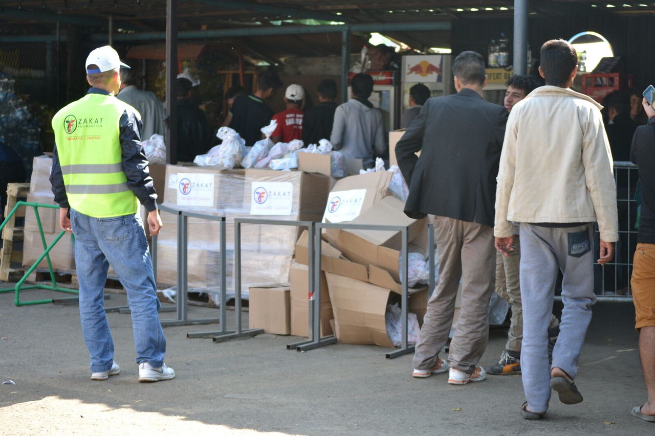 Families line up to receive relief items including nutritious food