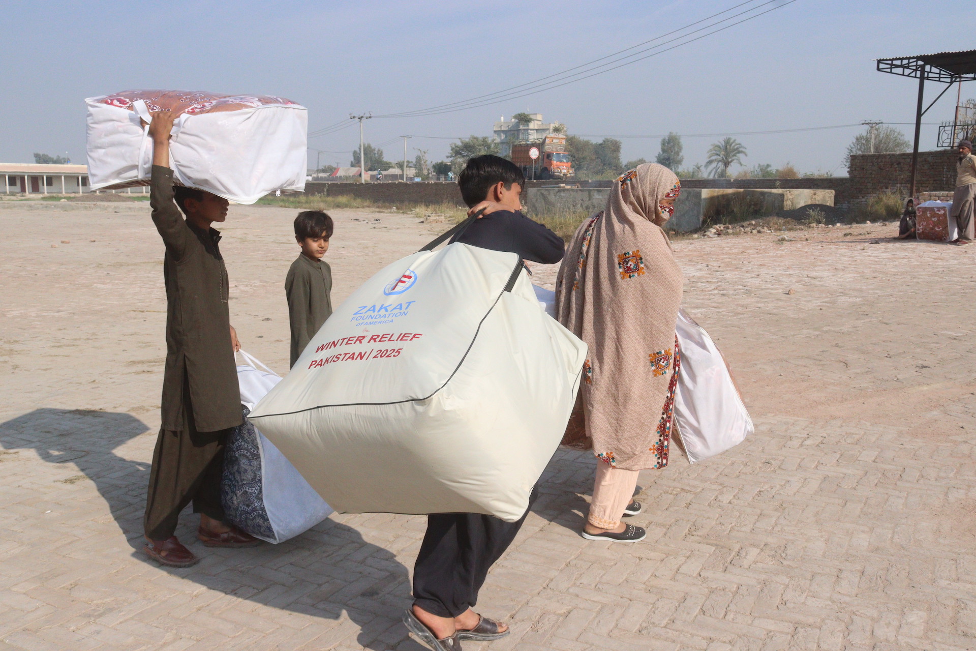 Families receive warm blankets and clothing at our winter relief distribution