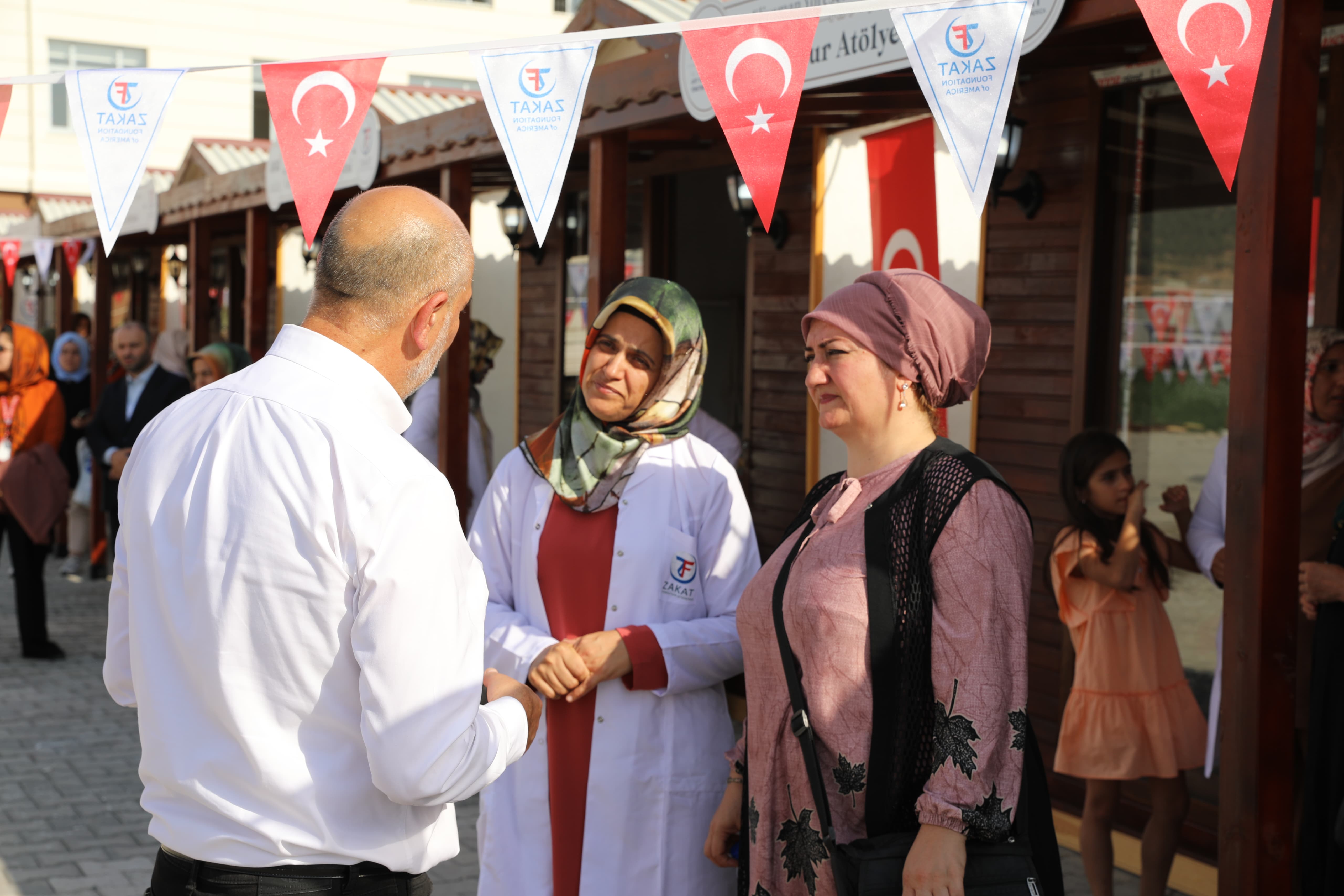 Mr. Halil Demir is greeted at the Eliyaman Women Empowerment training center by those seeking self-sufficiency