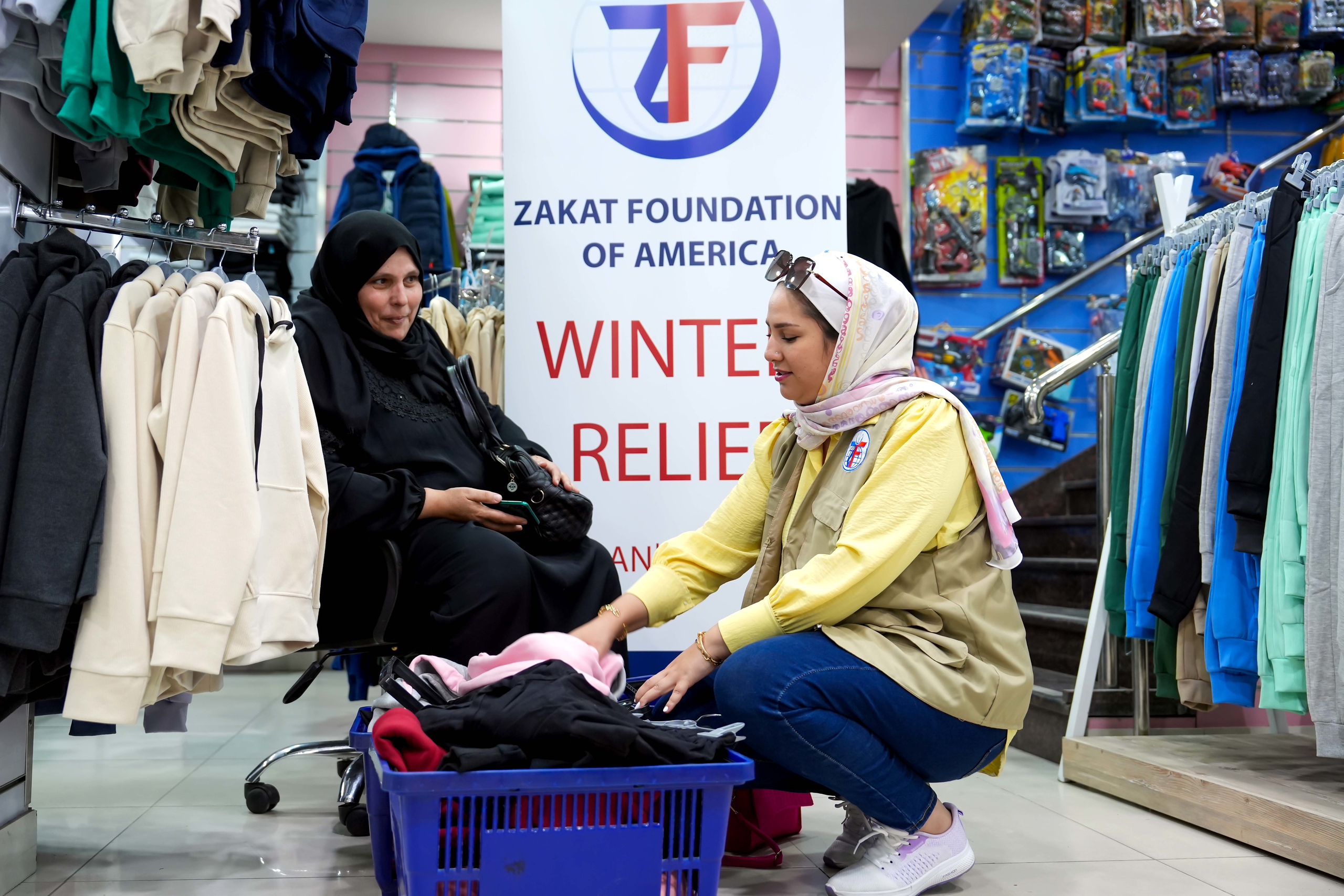 Orphan guardians take a moment to connect with our team while receiving winter items