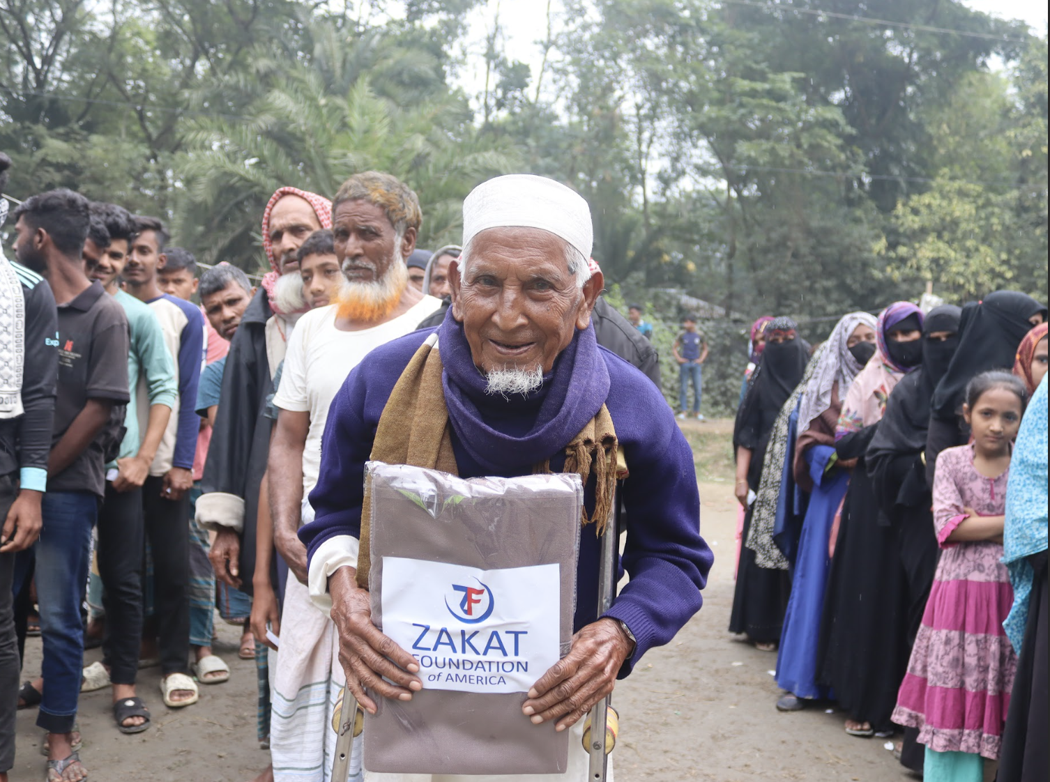 An elderly man in Bangladesh receives a warm shawl to help battle the winter chill