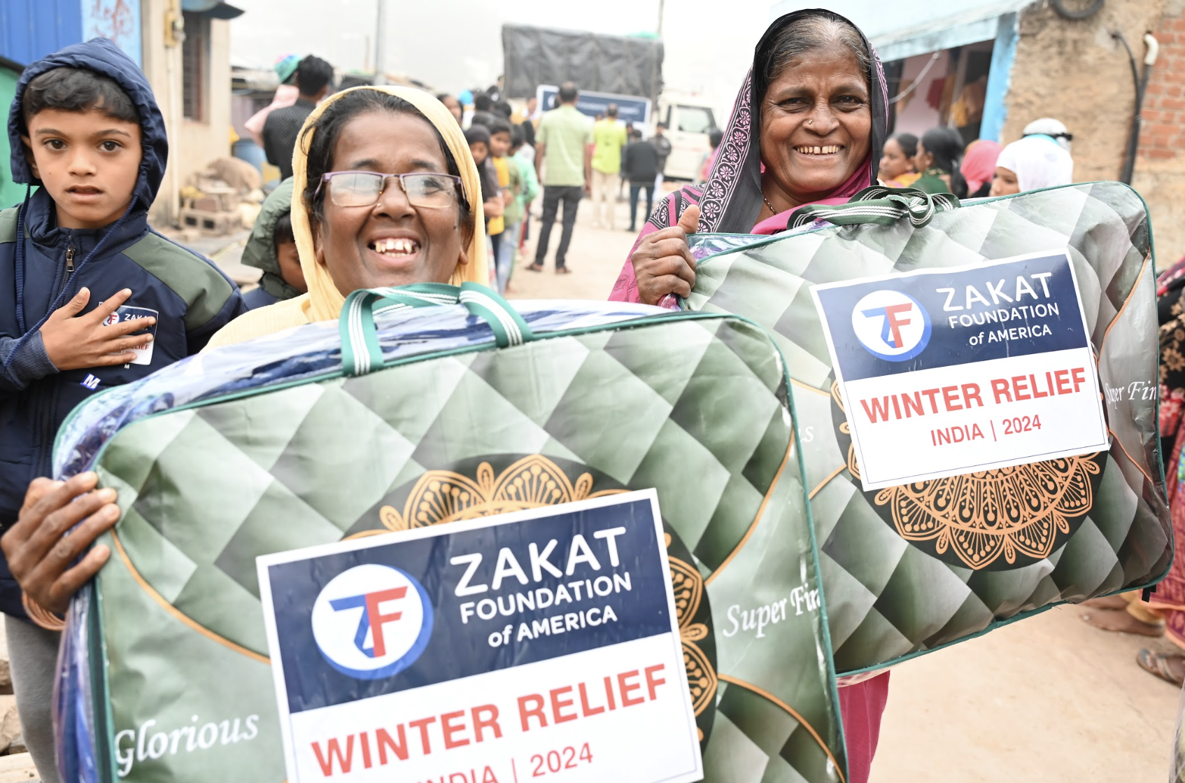 Mothers in India express their joy at receiving blankets to keep their families warm
