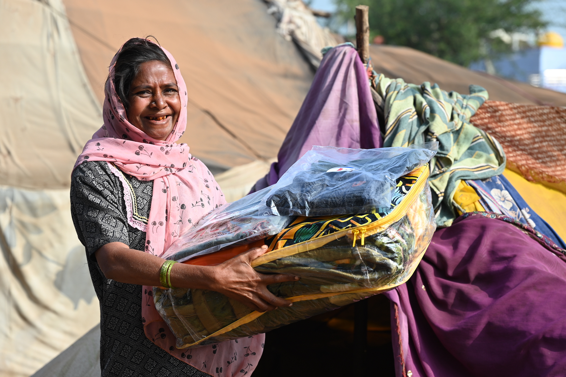 Smiles of relief and comfort are contagious when receiving winter kits by our teams