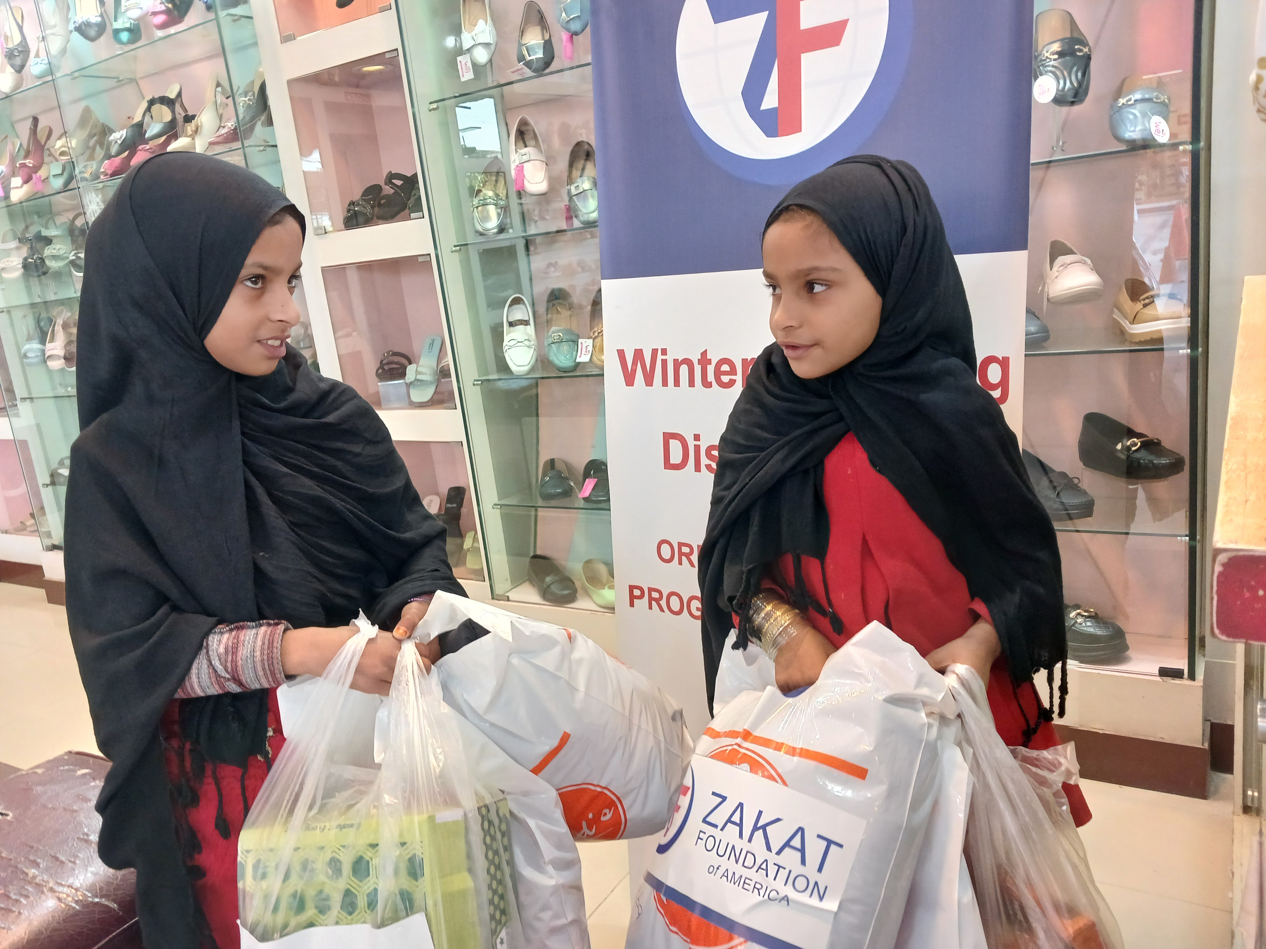 Sponsored orphans visit shopping centers to pick warm winter clothing