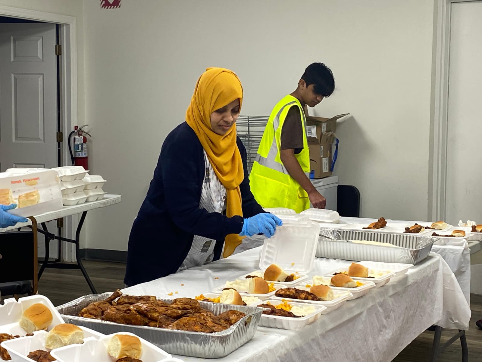 Volunteers put together warm meal boxes for community members in North Carolina