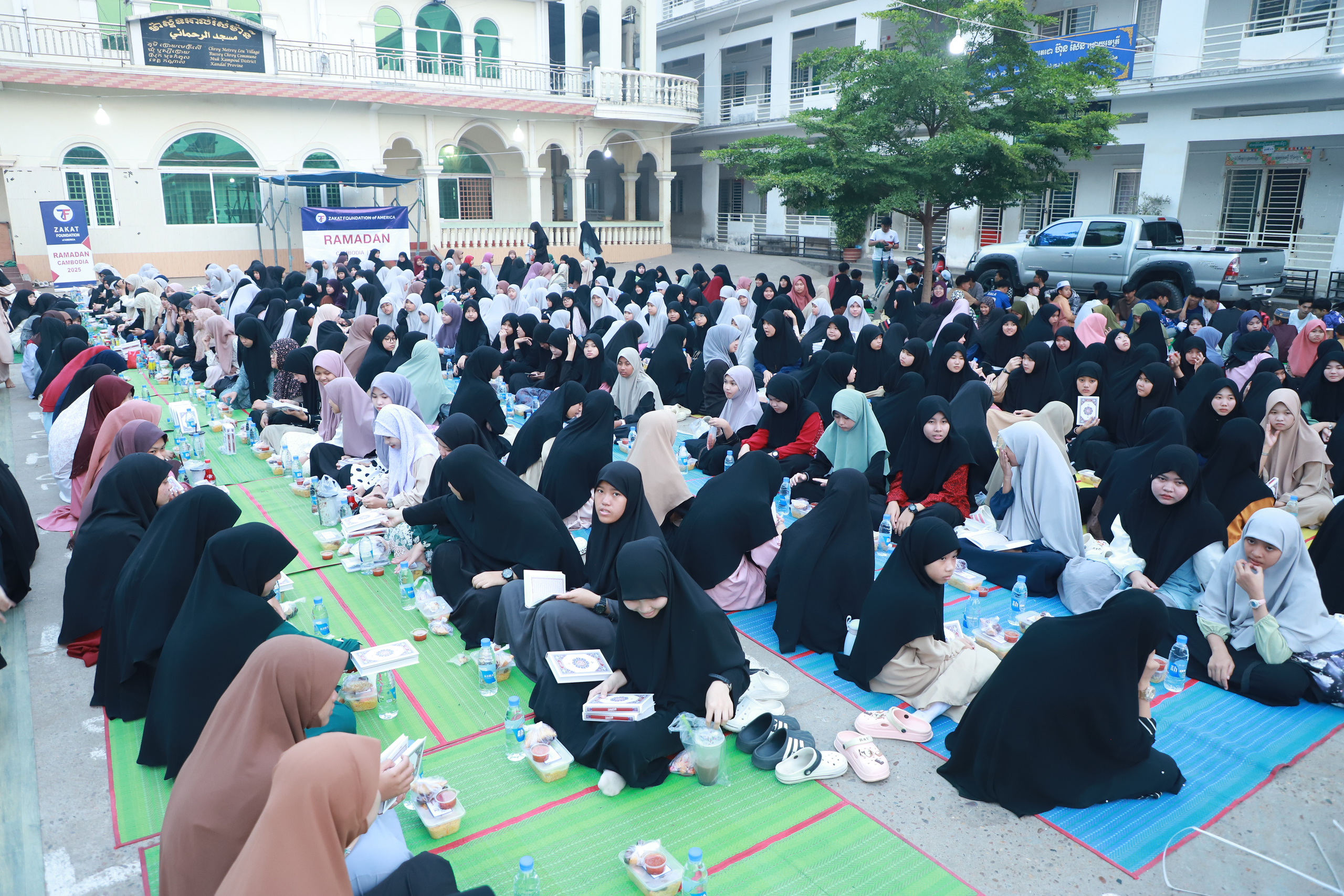 Women in Cambodia read Quran while they wait for iftar time at our iftar dinner
