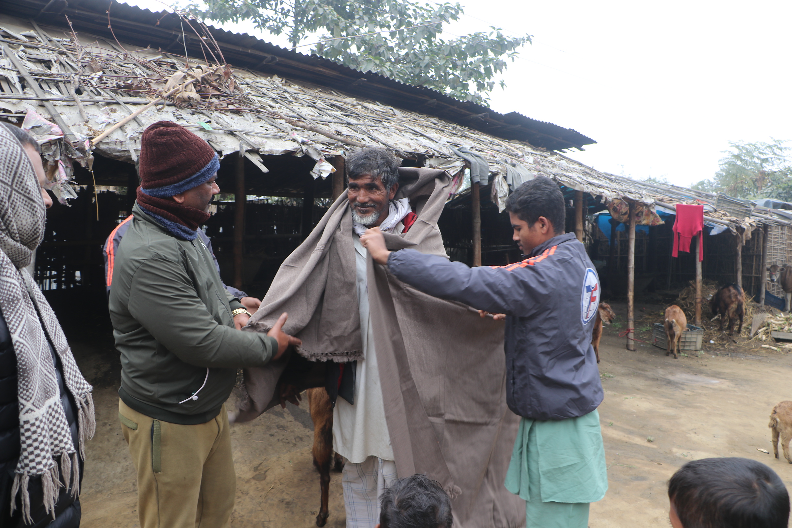 Wrapped with care, a man in Nepal receives a winter shawl